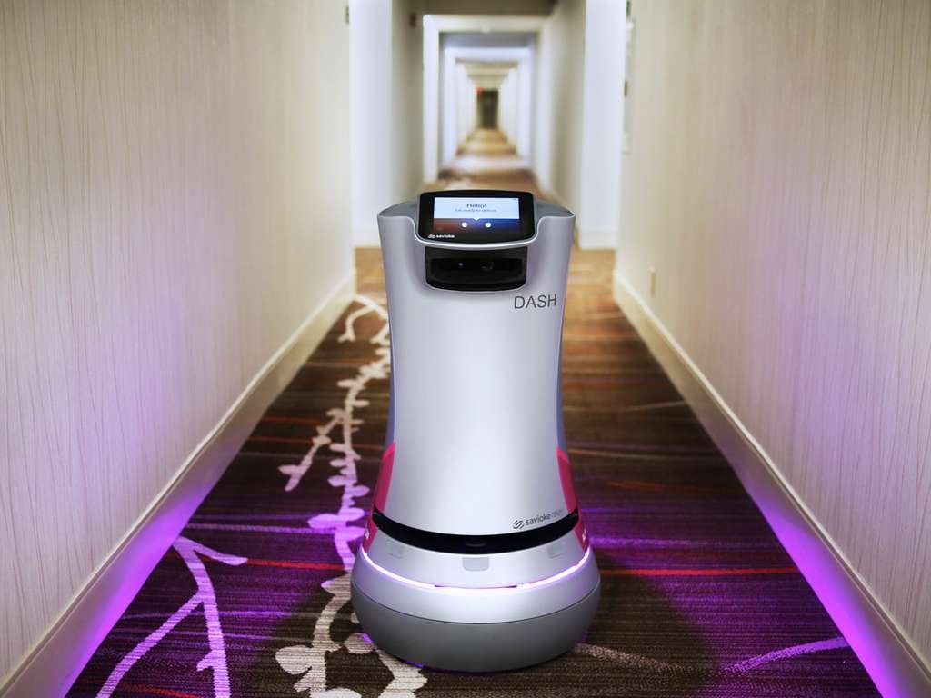 Hotels across the US are using room-service robots to assist guests and deliver food, amid staffing shortages